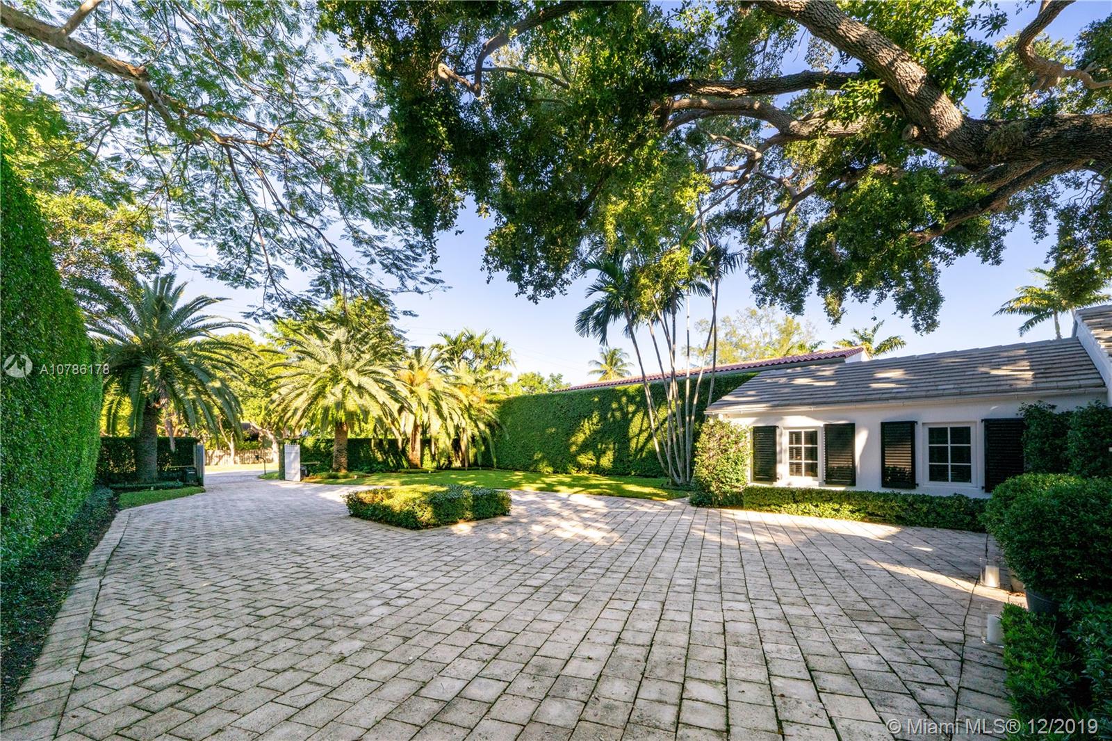 4955 Lakeview Drive Miami Beach, FL 33140 - Photo 12 of 55 a front view of a house with a yard