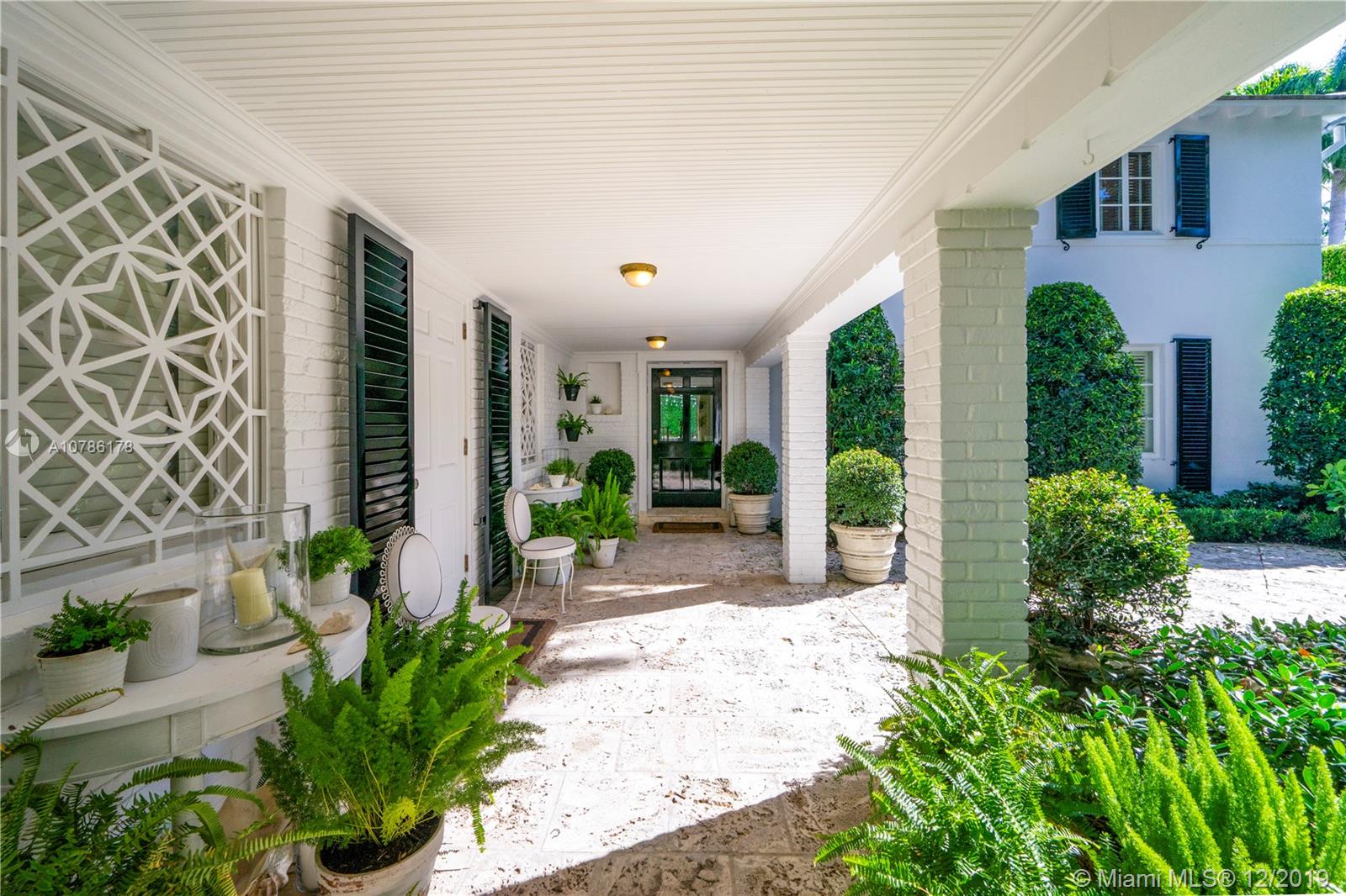 4955 Lakeview Drive Miami Beach, FL 33140 - Photo 13 of 55 a view of a entryway door with potted plants in front of house
