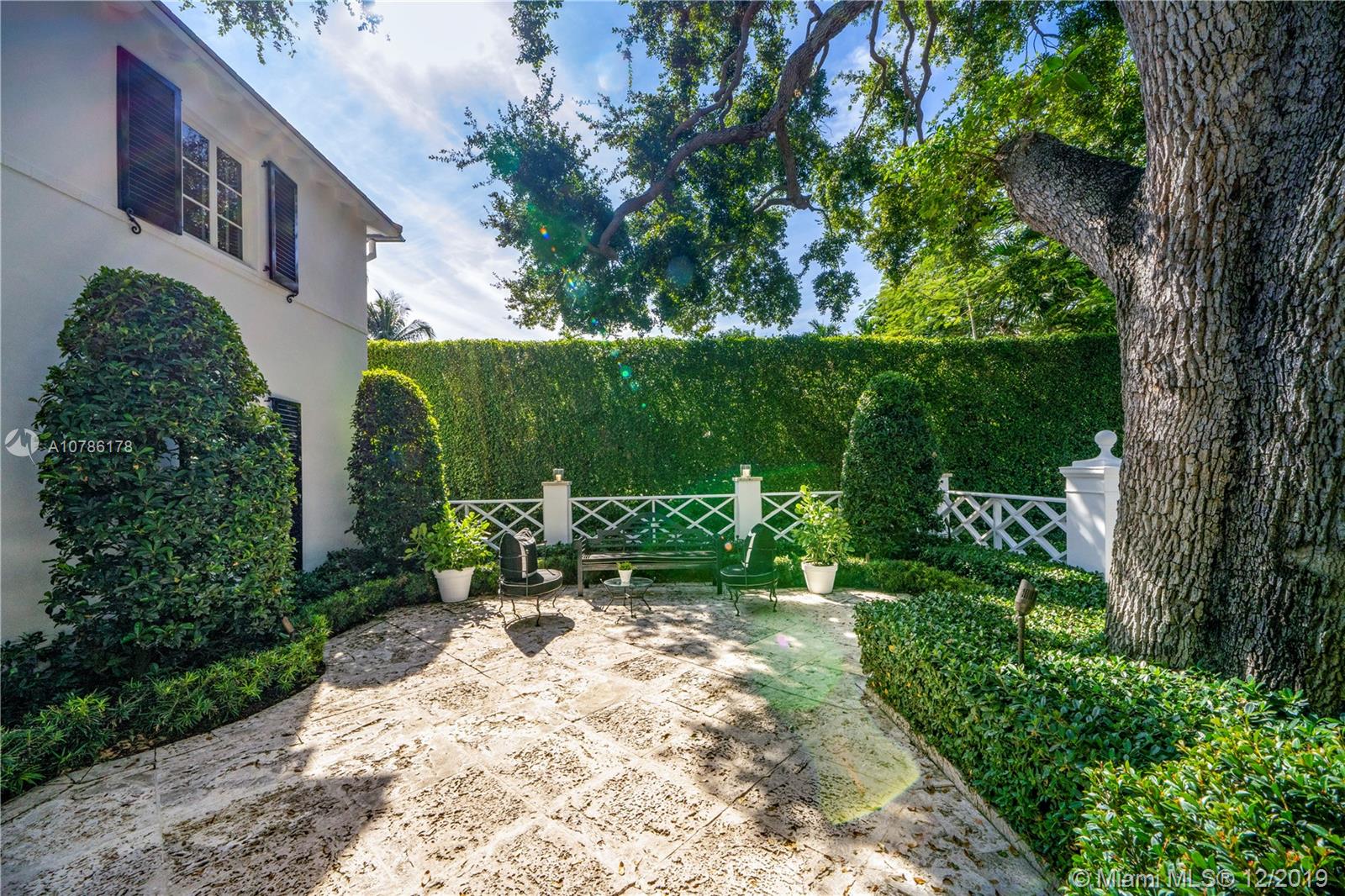 4955 Lakeview Drive Miami Beach, FL 33140 - Photo 15 of 55 a view of a chair and table in backyard of the house