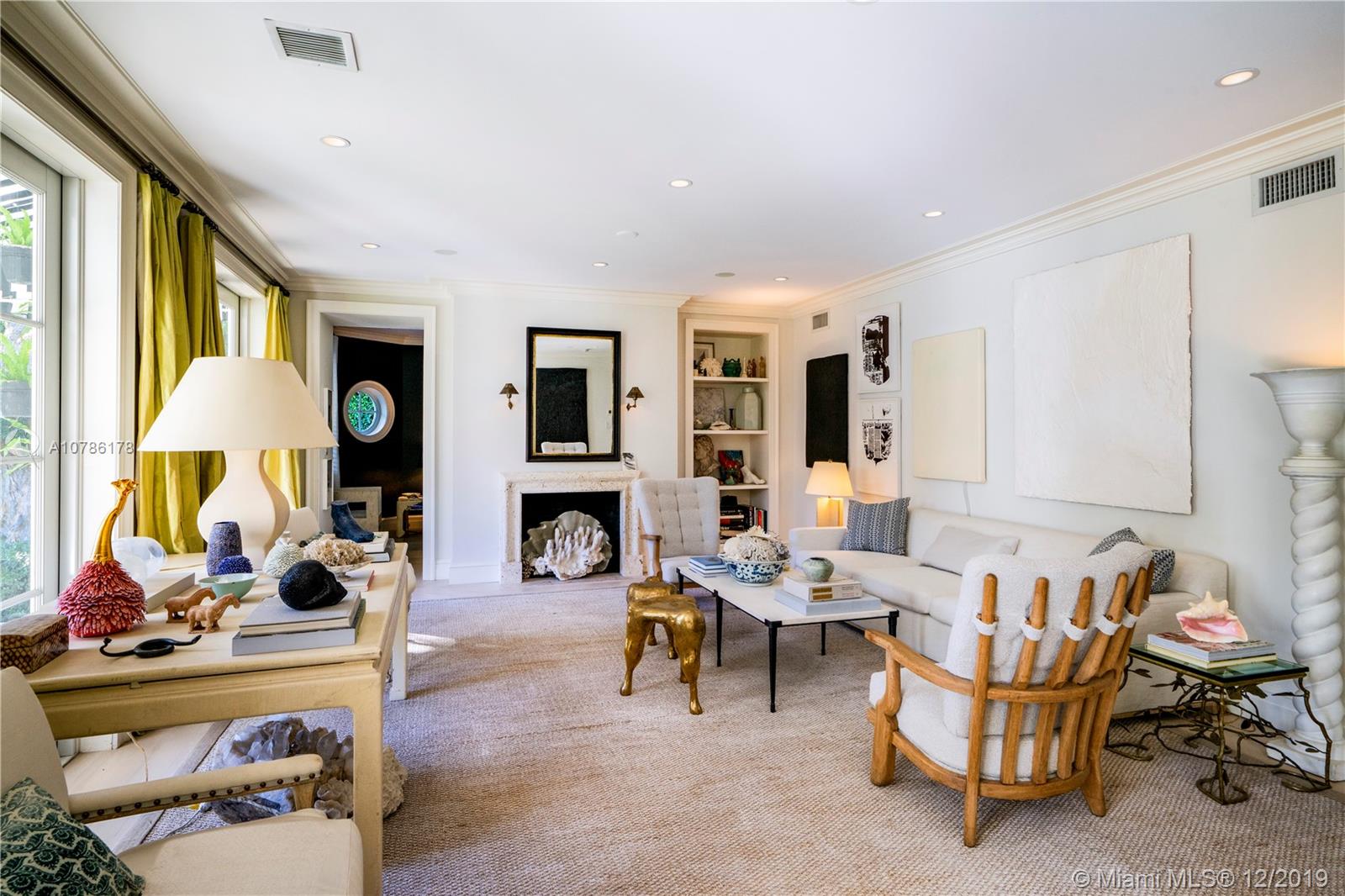 4955 Lakeview Drive Miami Beach, FL 33140 - Photo 16 of 55 a living room with furniture a fireplace and a table