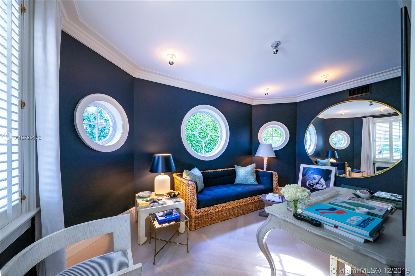 4955 Lakeview Drive Miami Beach, FL 33140 - Photo 27 of 55 a living room with baby furniture a clock and a window