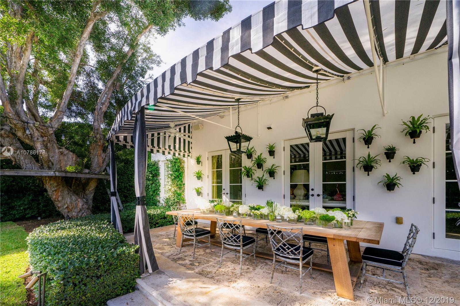 4955 Lakeview Drive Miami Beach, FL 33140 - Photo 29 of 55 a view of a patio with table and chairs and potted plants