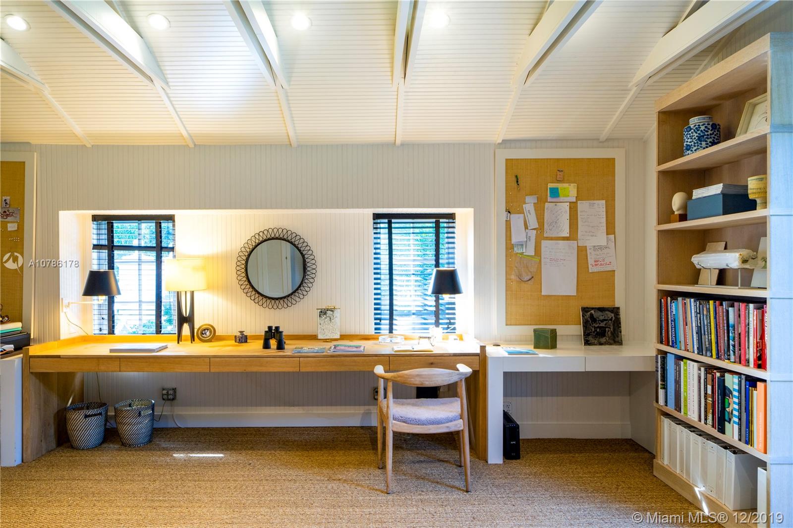 4955 Lakeview Drive Miami Beach, FL 33140 - Photo 35 of 55 a living room with a couch and bookshelf