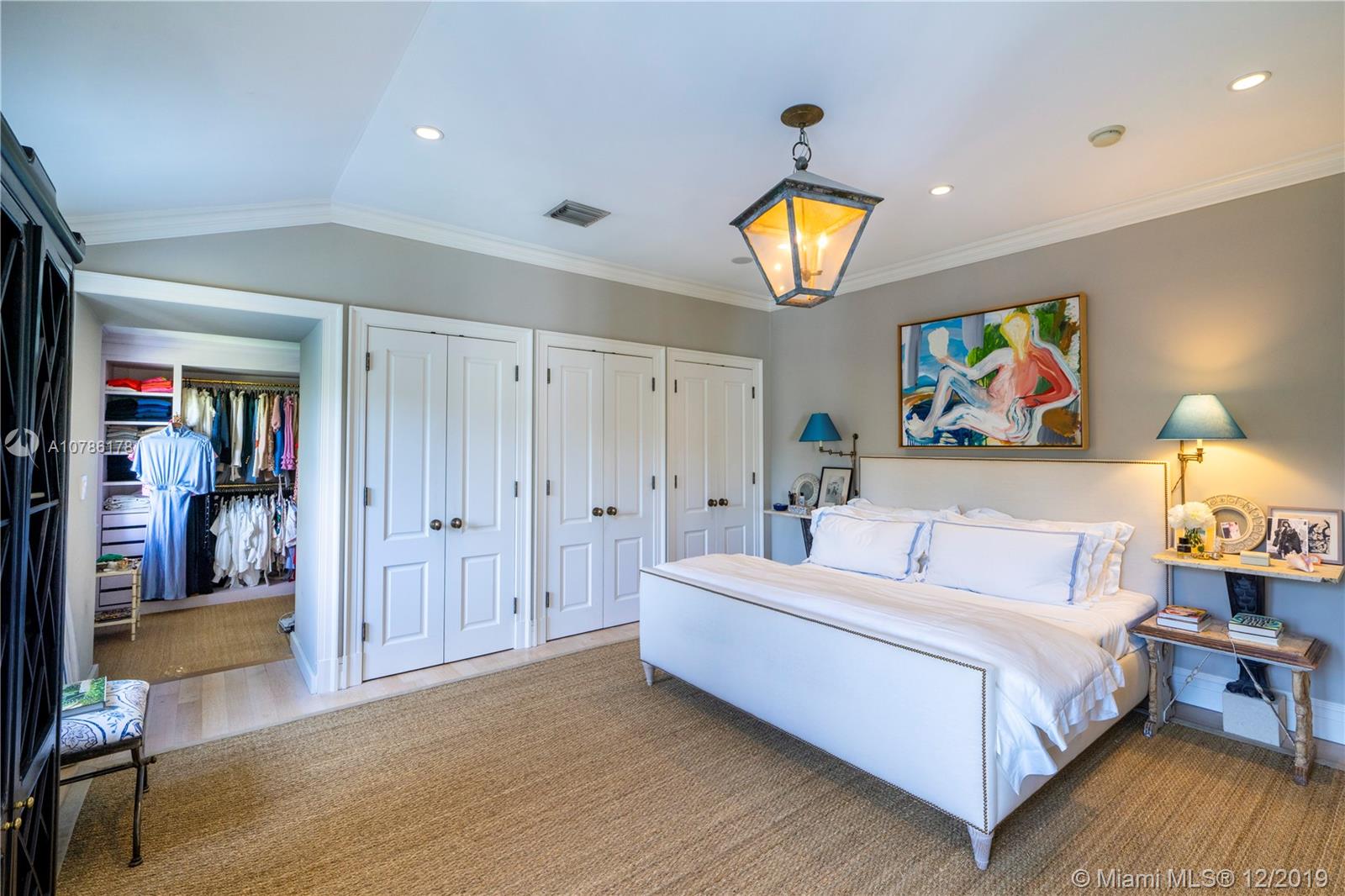 4955 Lakeview Drive Miami Beach, FL 33140 - Photo 43 of 55 a spacious bedroom with a bed and painting on the wall