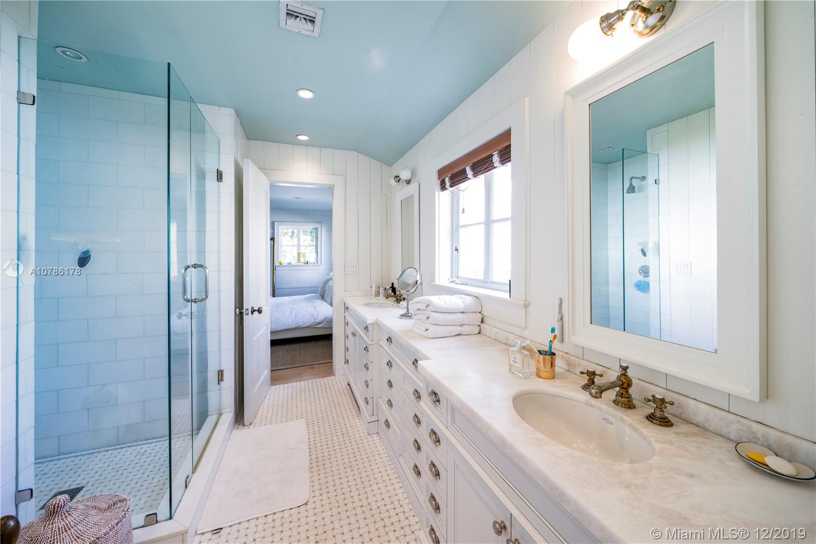 4955 Lakeview Drive Miami Beach, FL 33140 - Photo 46 of 55 a spacious bathroom with a double vanity sink mirror and shower