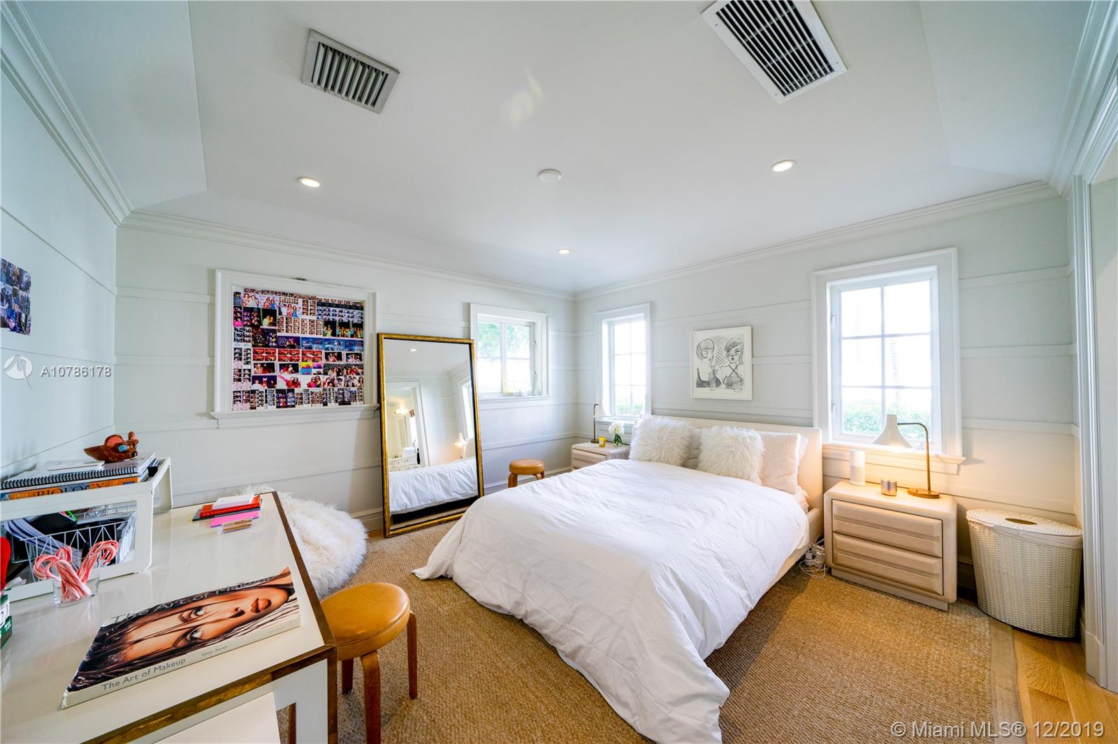 4955 Lakeview Drive Miami Beach, FL 33140 - Photo 47 of 55 a bedroom with a bed and wooden floor