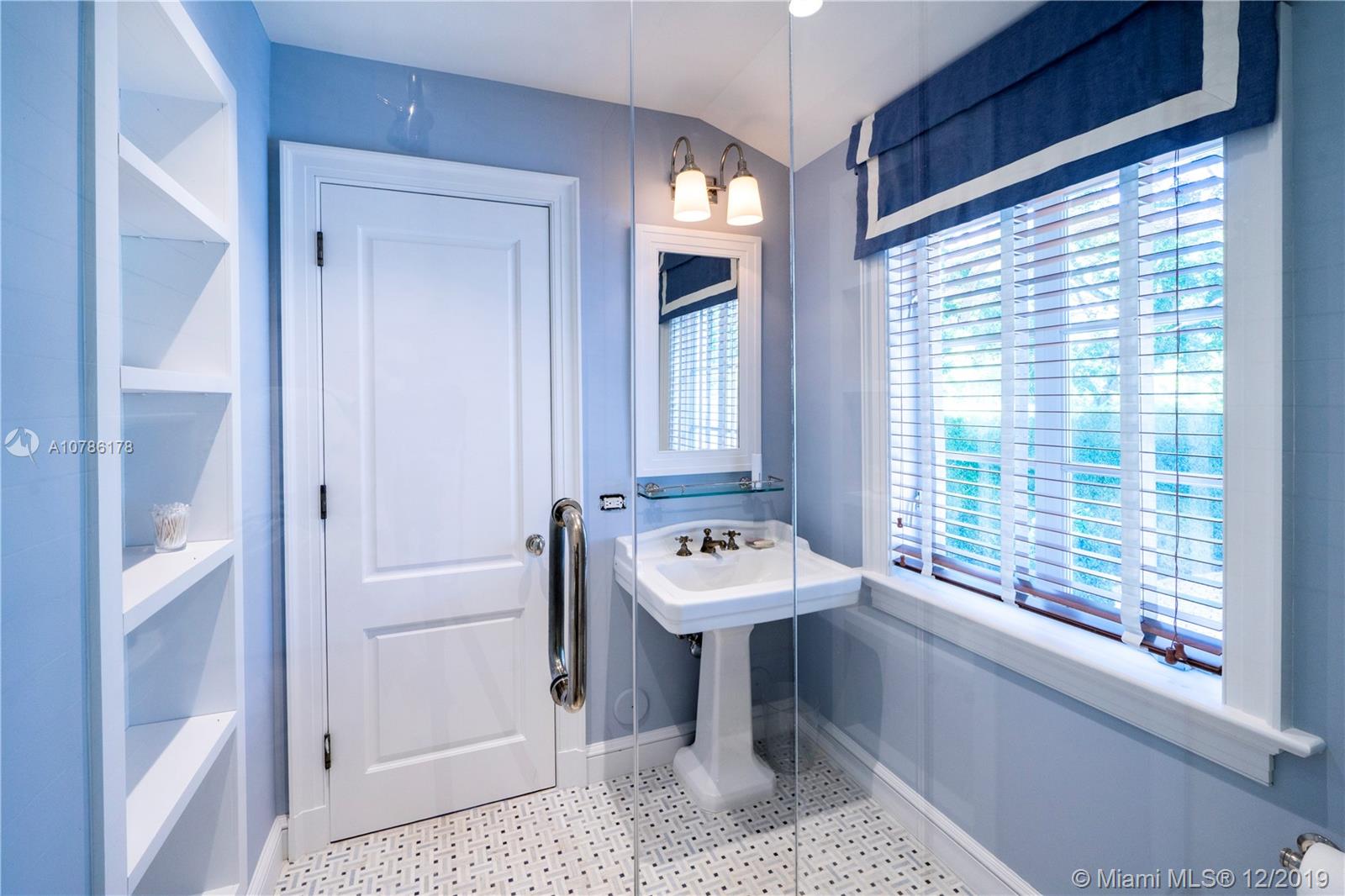 4955 Lakeview Drive Miami Beach, FL 33140 - Photo 52 of 55 a bathroom with a sink a toilet and tub