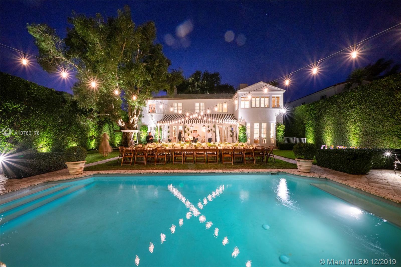 4955 Lakeview Drive Miami Beach, FL 33140 - Photo 55 of 55 a view of a swimming pool with an outdoor seating and a yard