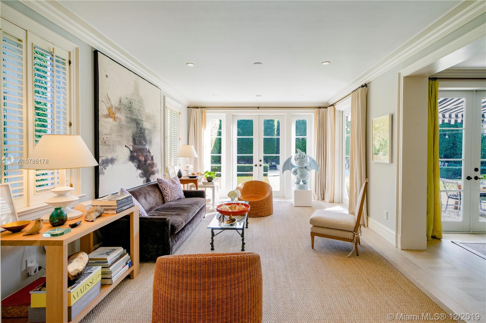 4955 Lakeview Drive Miami Beach, FL 33140 - Photo 9 of 55 a living room with furniture and a floor to ceiling window