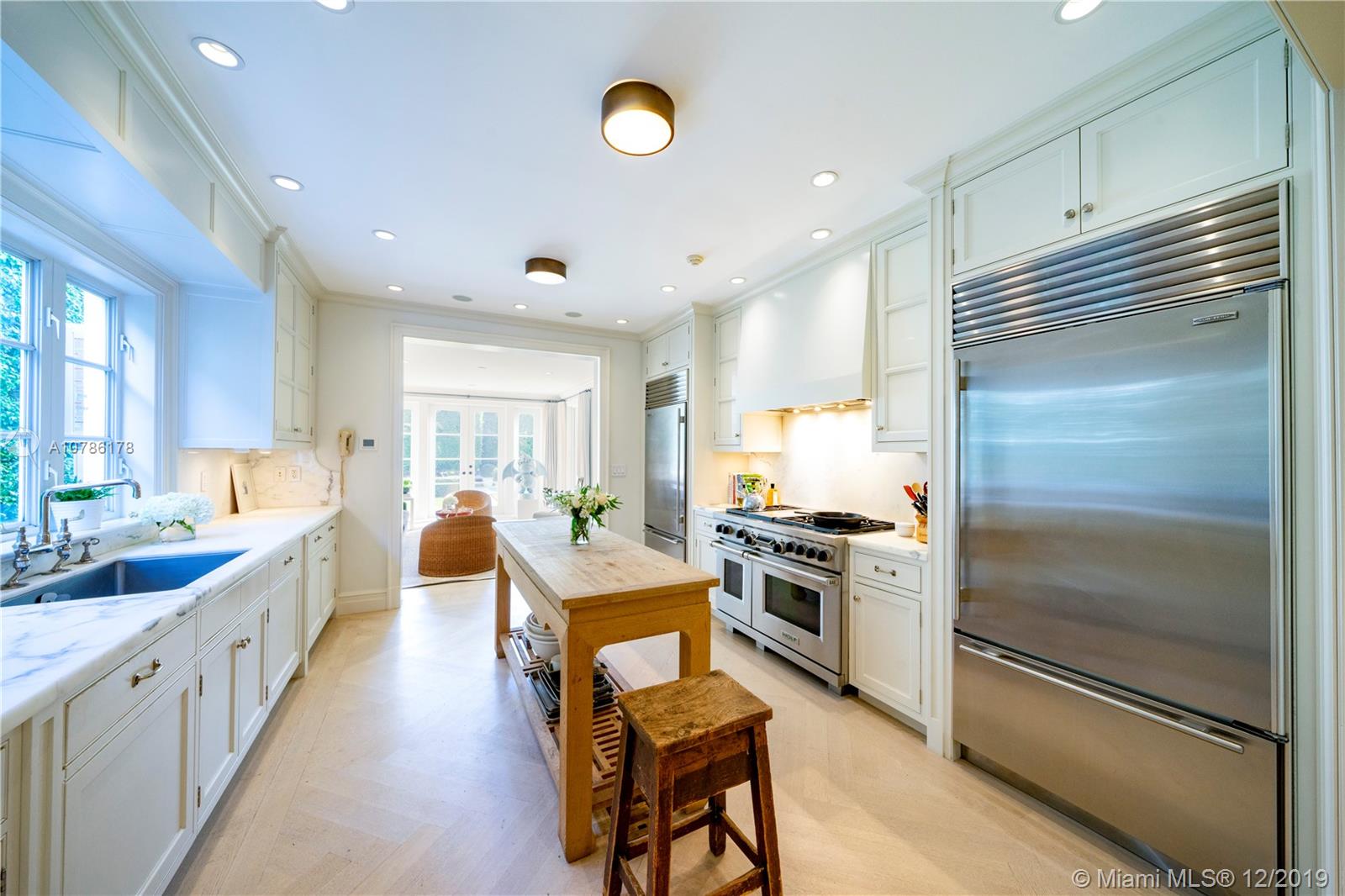 4955 Lakeview Drive Miami Beach, FL 33140 - Photo 10 of 55 a very nice looking kitchen with a large counter space a sink and stainless steel appliances
