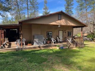13769 Yuba-Nevada Road Dobbins, CA 95935 - Photo 2 of 18 a view of a backyard with table and chairs under an umbrella