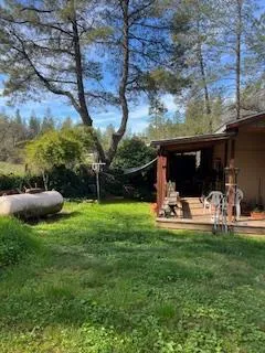 a view of a backyard with table and chairs and potted plants