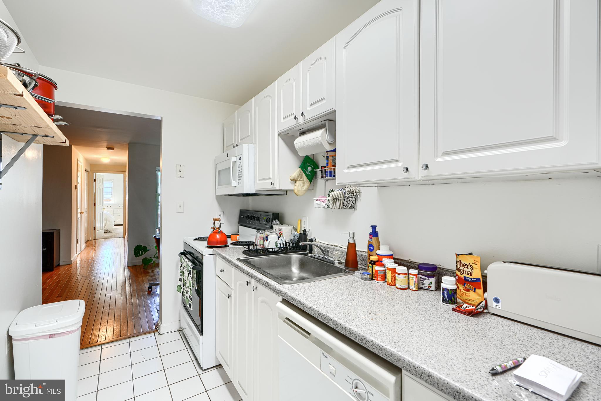 1312 South Hanover Street Baltimore, MD 21230 - Photo 20 of 53 a kitchen with a white cabinets and white appliances