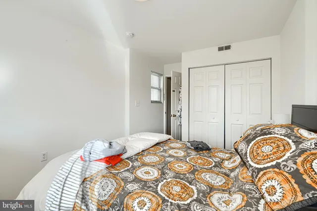 a view of a bedroom with furniture and wooden floor
