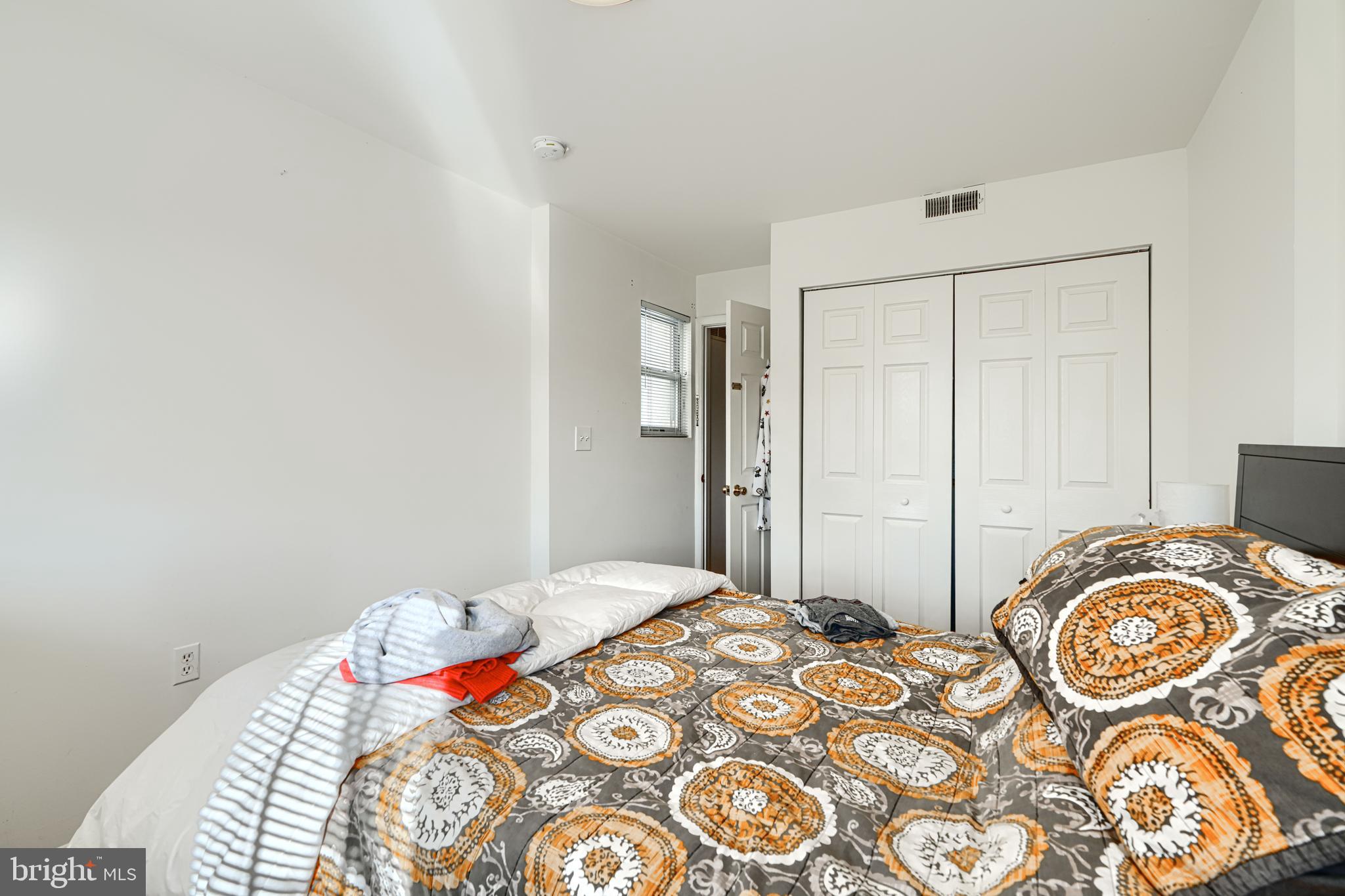 1312 South Hanover Street Baltimore, MD 21230 - Photo 24 of 53 a bedroom with a bed and a chandelier