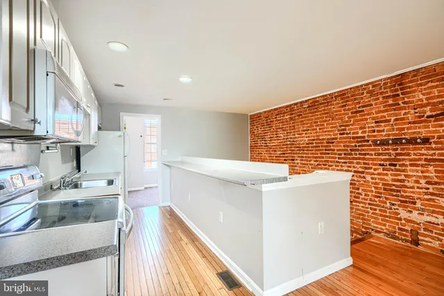 a kitchen with stainless steel appliances a refrigerator and a stove