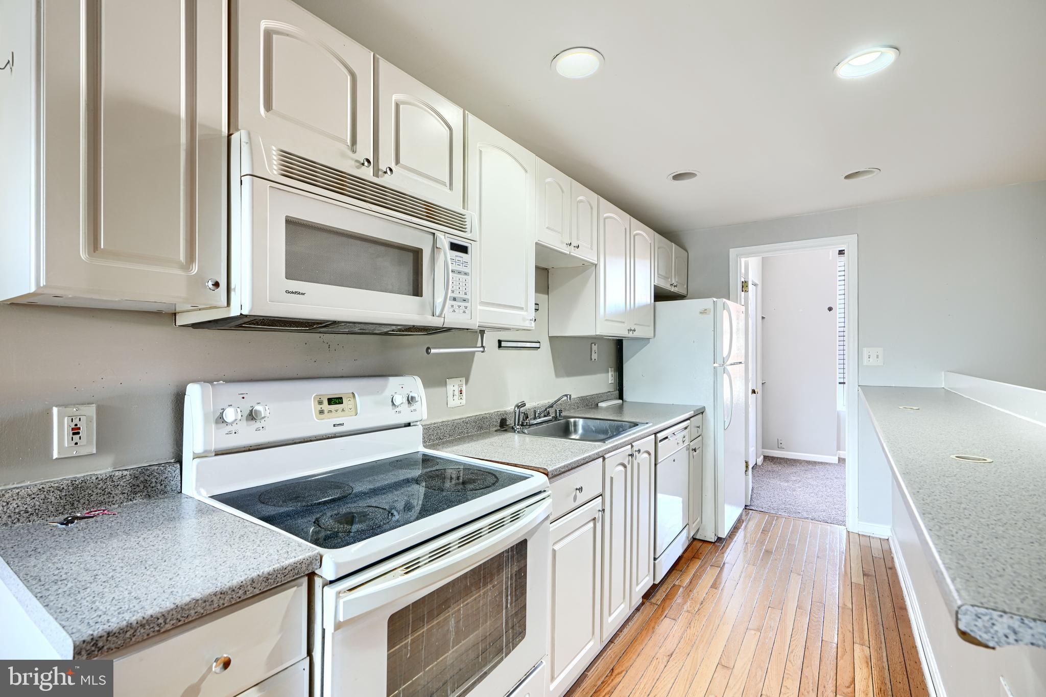 1312 South Hanover Street Baltimore, MD 21230 - Photo 38 of 53 a kitchen with stainless steel appliances granite countertop a stove and a refrigerator