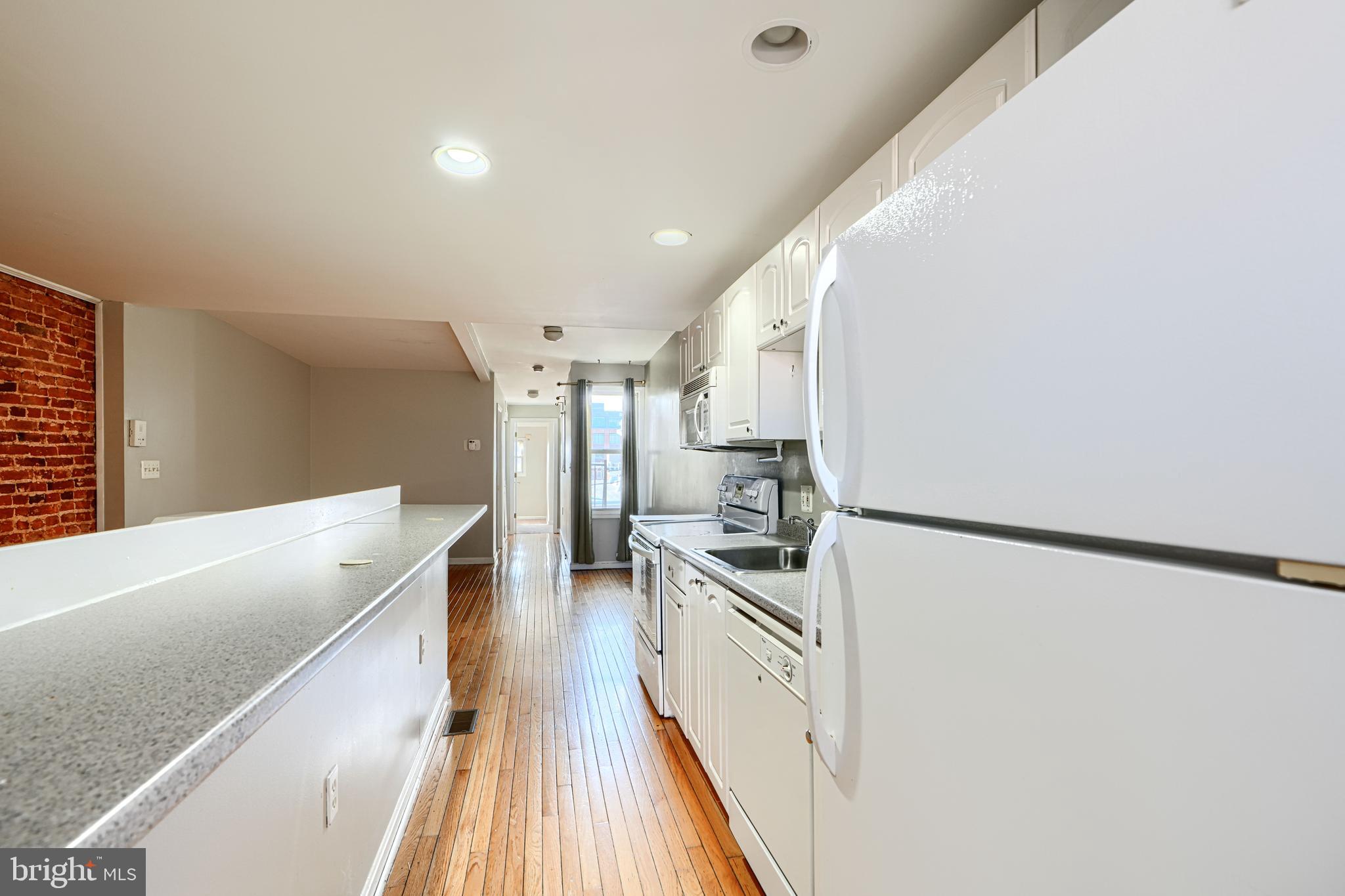1312 South Hanover Street Baltimore, MD 21230 - Photo 39 of 53 a kitchen with stainless steel appliances a refrigerator and a stove
