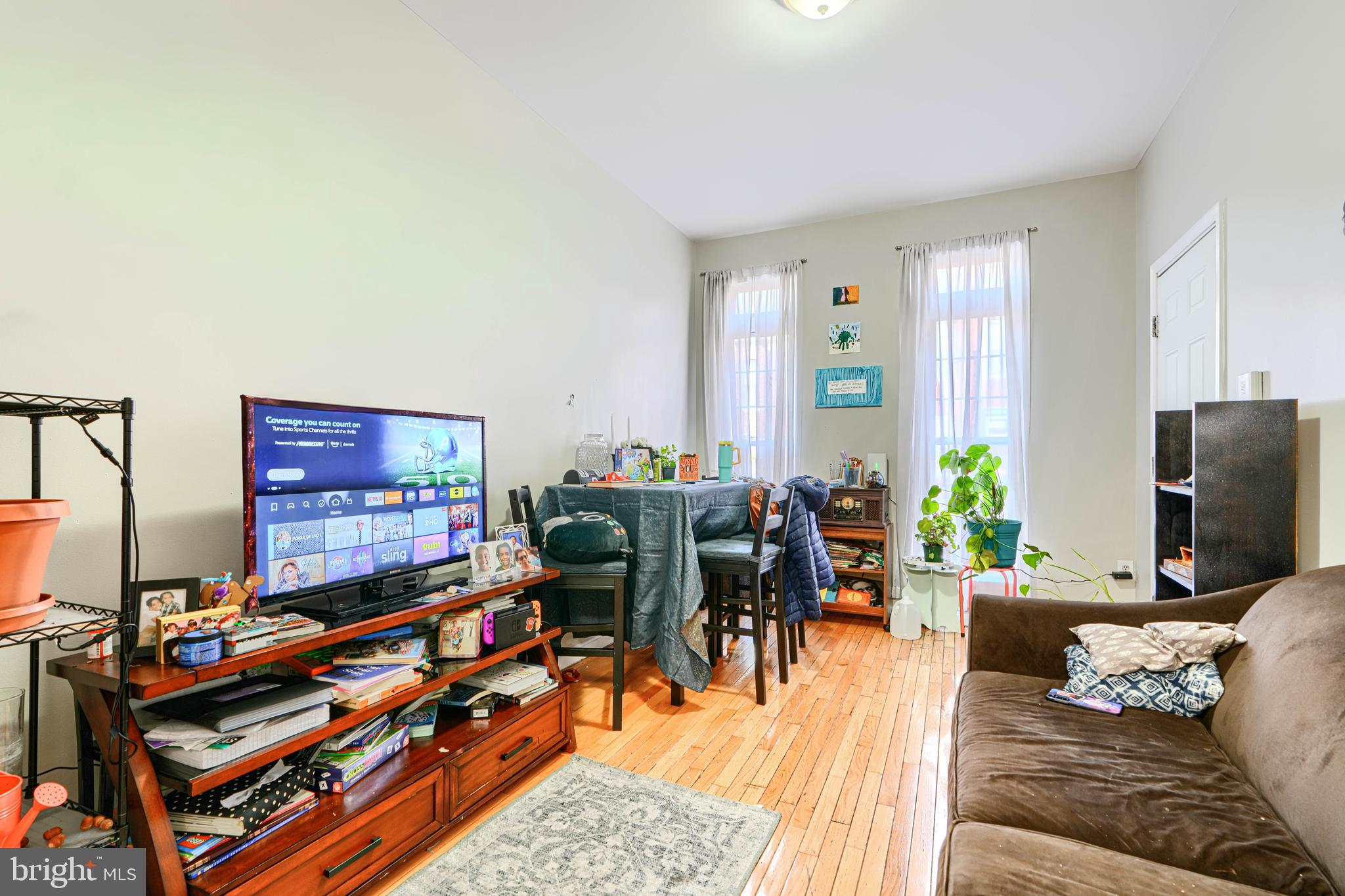 1312 South Hanover Street Baltimore, MD 21230 - Photo 6 of 53 a living room with furniture a bookshelf and a flat screen tv