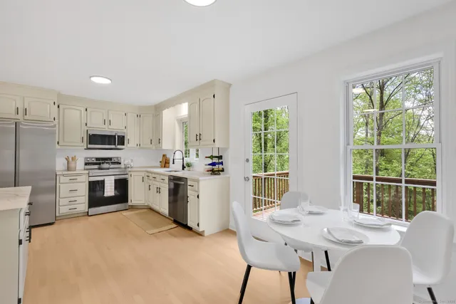 a kitchen with white cabinets and stainless steel appliances