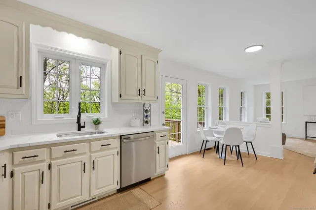 a large white kitchen with a large window