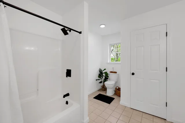 a bathroom with a bathtub and shower