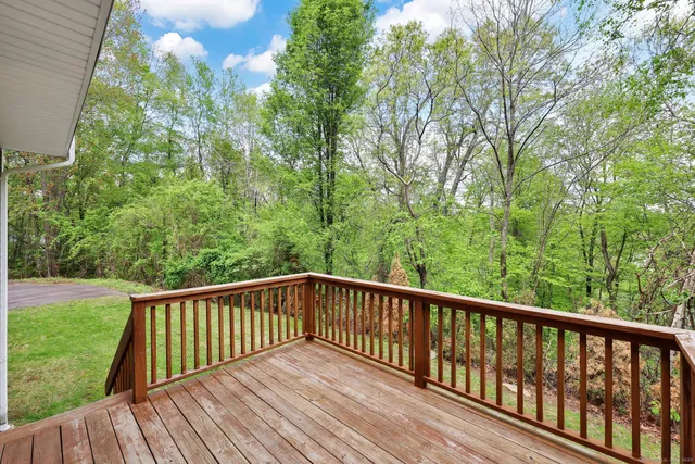 a view of balcony with deck and trees