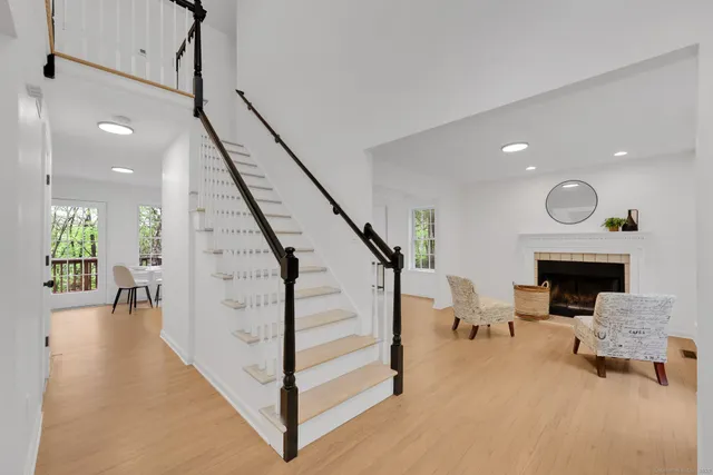 a view of entryway and hall with wooden floor