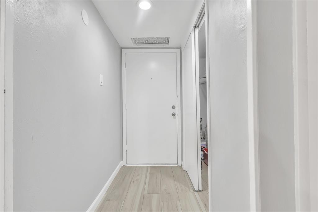 4837 Cedar Springs Road, Unit 321 Dallas, TX 75219 - Photo 11 of 14 a view of a room with wooden floor and a door