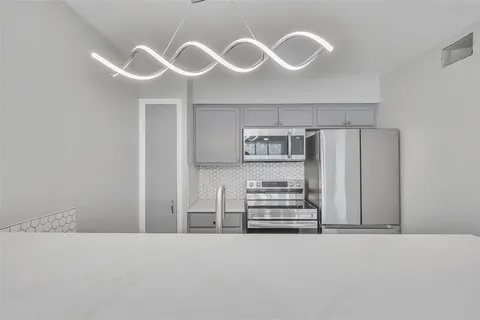 a kitchen with cabinets and window