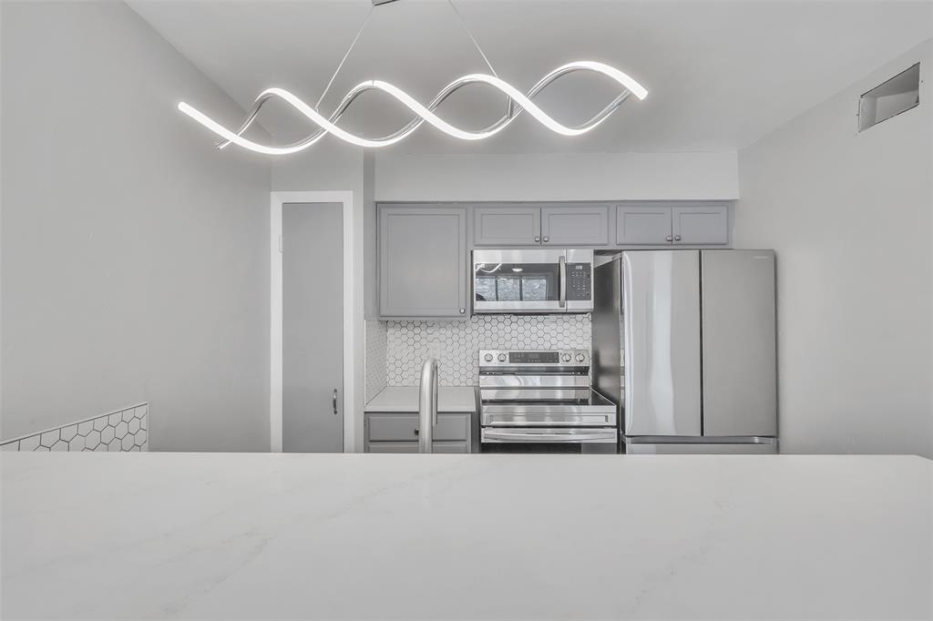 4837 Cedar Springs Road, Unit 321 Dallas, TX 75219 - Photo 6 of 14 a kitchen with cabinets and window