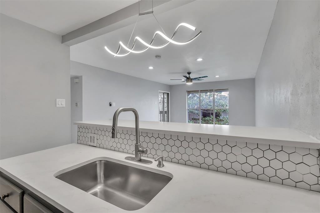 4837 Cedar Springs Road, Unit 321 Dallas, TX 75219 - Photo 7 of 14 a close view of a sink a faucet and chandelier