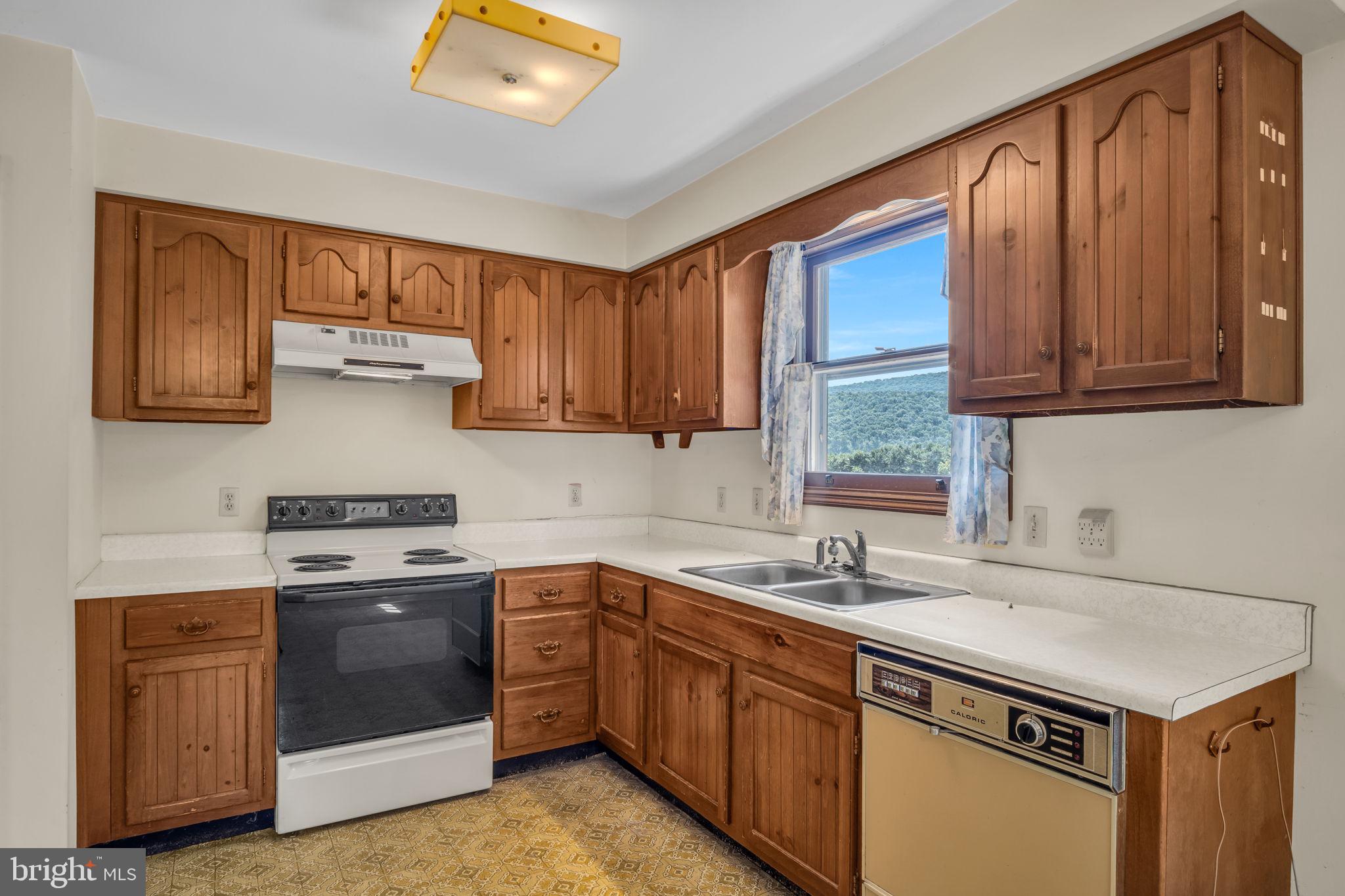 609 Dellville Road Duncannon, PA 17020 - Photo 4 of 48 a kitchen with a sink stove and microwave