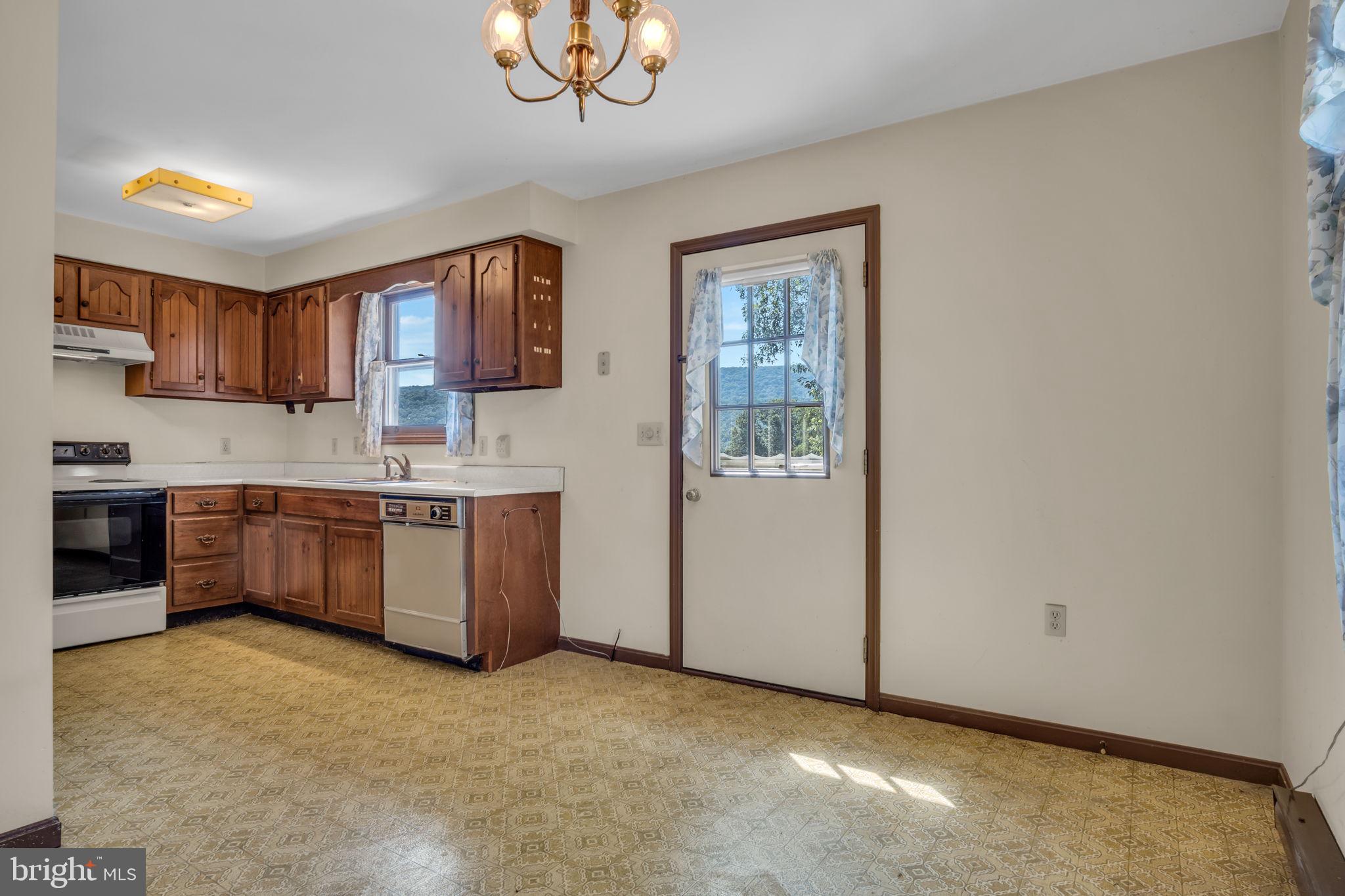 609 Dellville Road Duncannon, PA 17020 - Photo 7 of 48 a kitchen with a stove a sink and a refrigerator