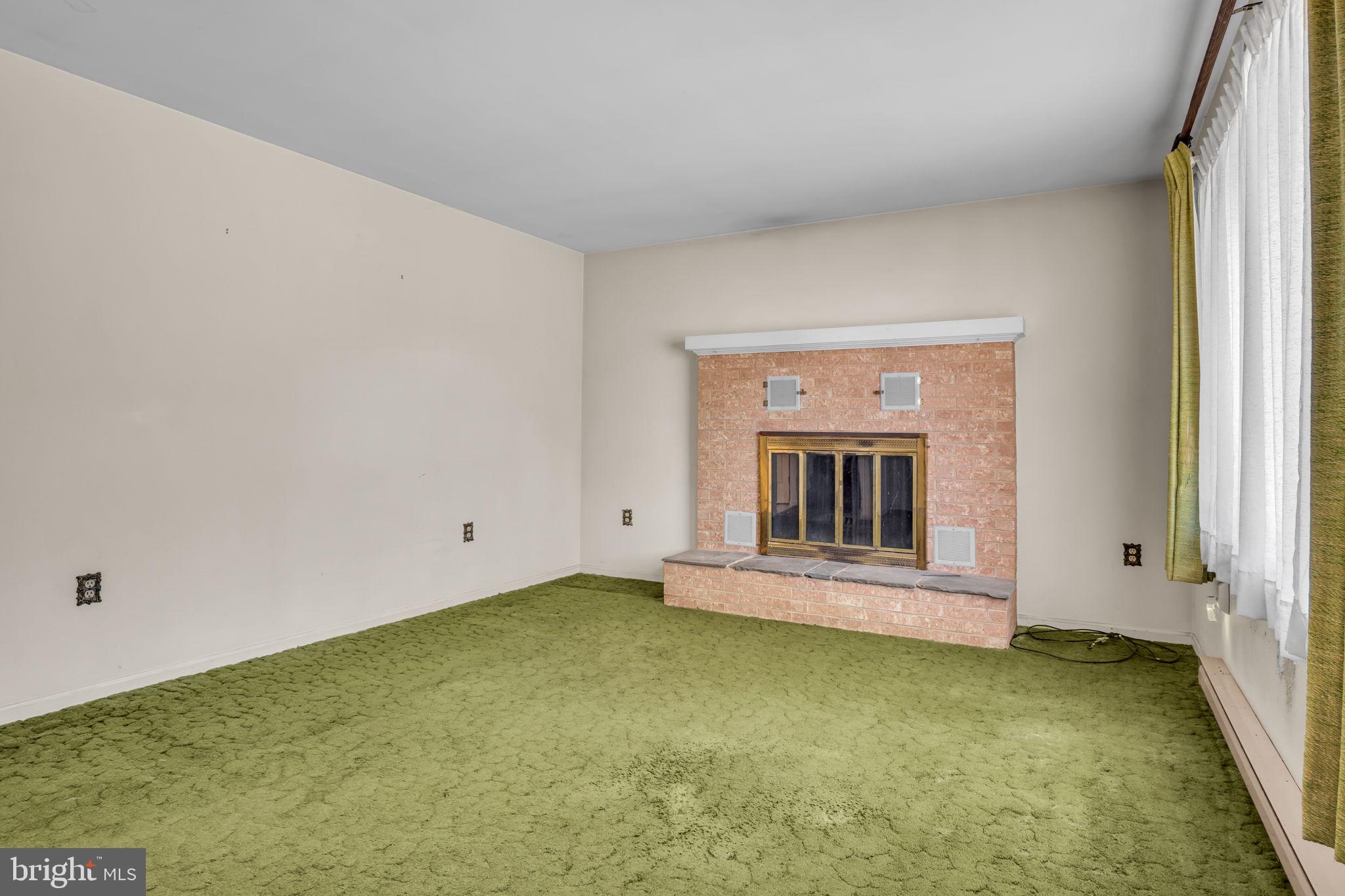 609 Dellville Road Duncannon, PA 17020 - Photo 8 of 48 a view of an empty room with a fireplace and a window