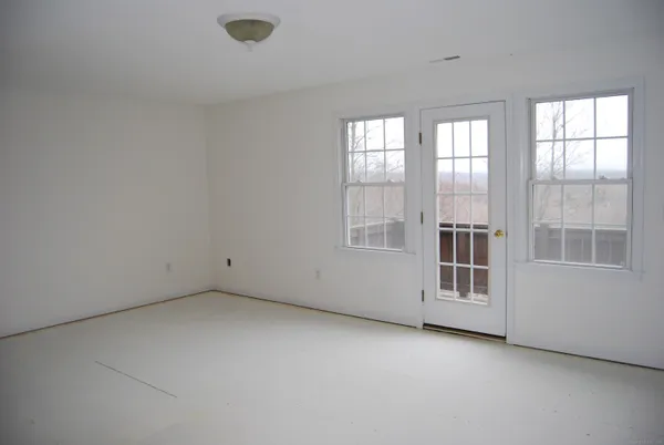 a view of a hallway with front door wooden floor and stairs