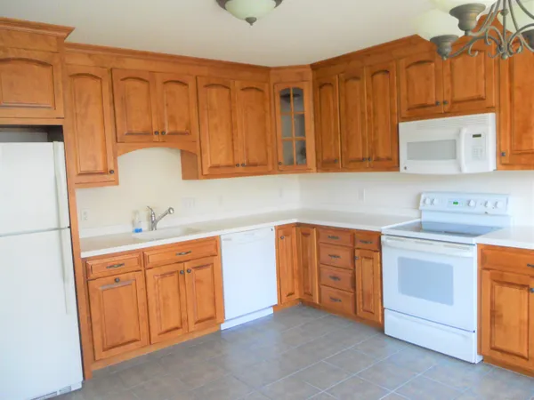 a kitchen with stainless steel appliances granite countertop a sink dishwasher stove and cabinets