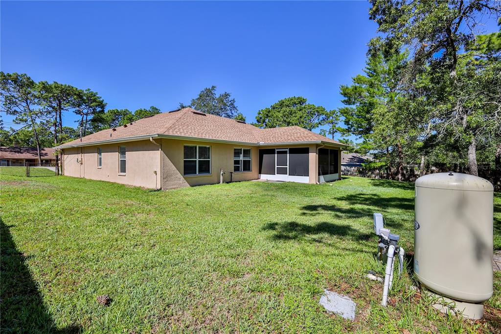 11213 Flock Avenue Weeki Wachee, FL 34613 - Photo 40 of 46 a front view of a house with a yard