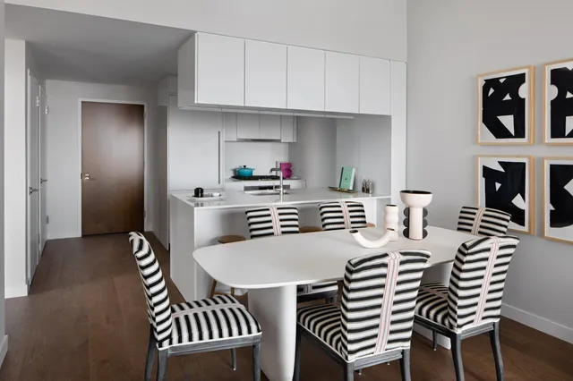 a kitchen that has a table and chairs in it
