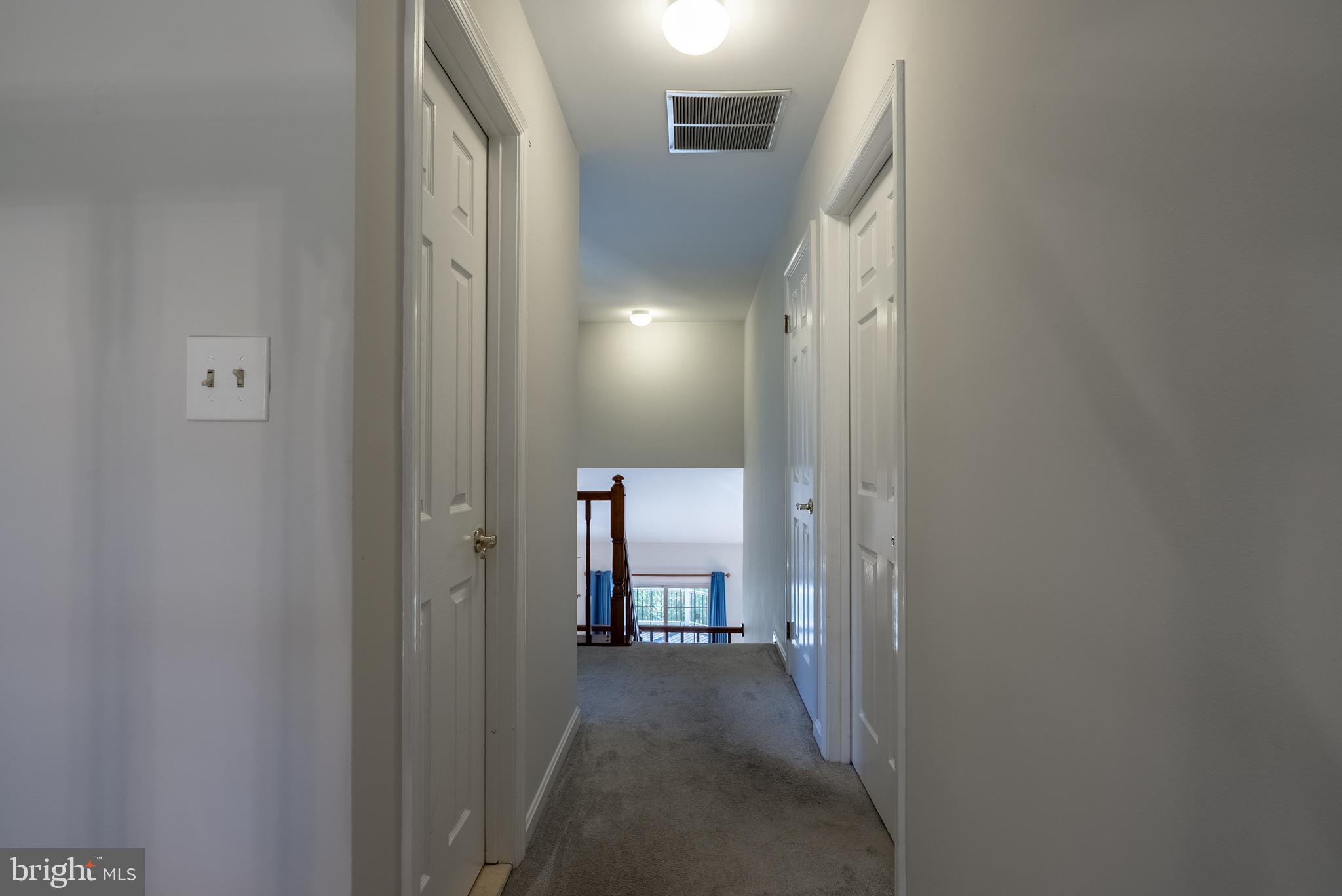 8007 Craddock Road Greenbelt, MD 20770 - Photo 21 of 59 Bright and inviting hallway with doors ahead.