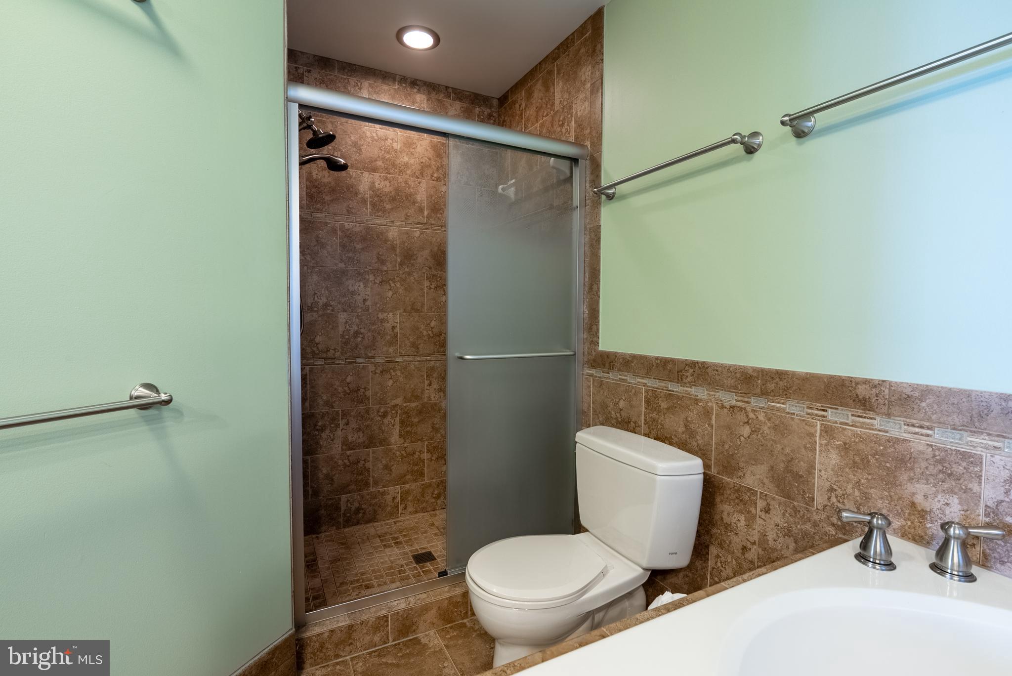 8007 Craddock Road Greenbelt, MD 20770 - Photo 26 of 59 Modern bathroom with elegant tile accents.