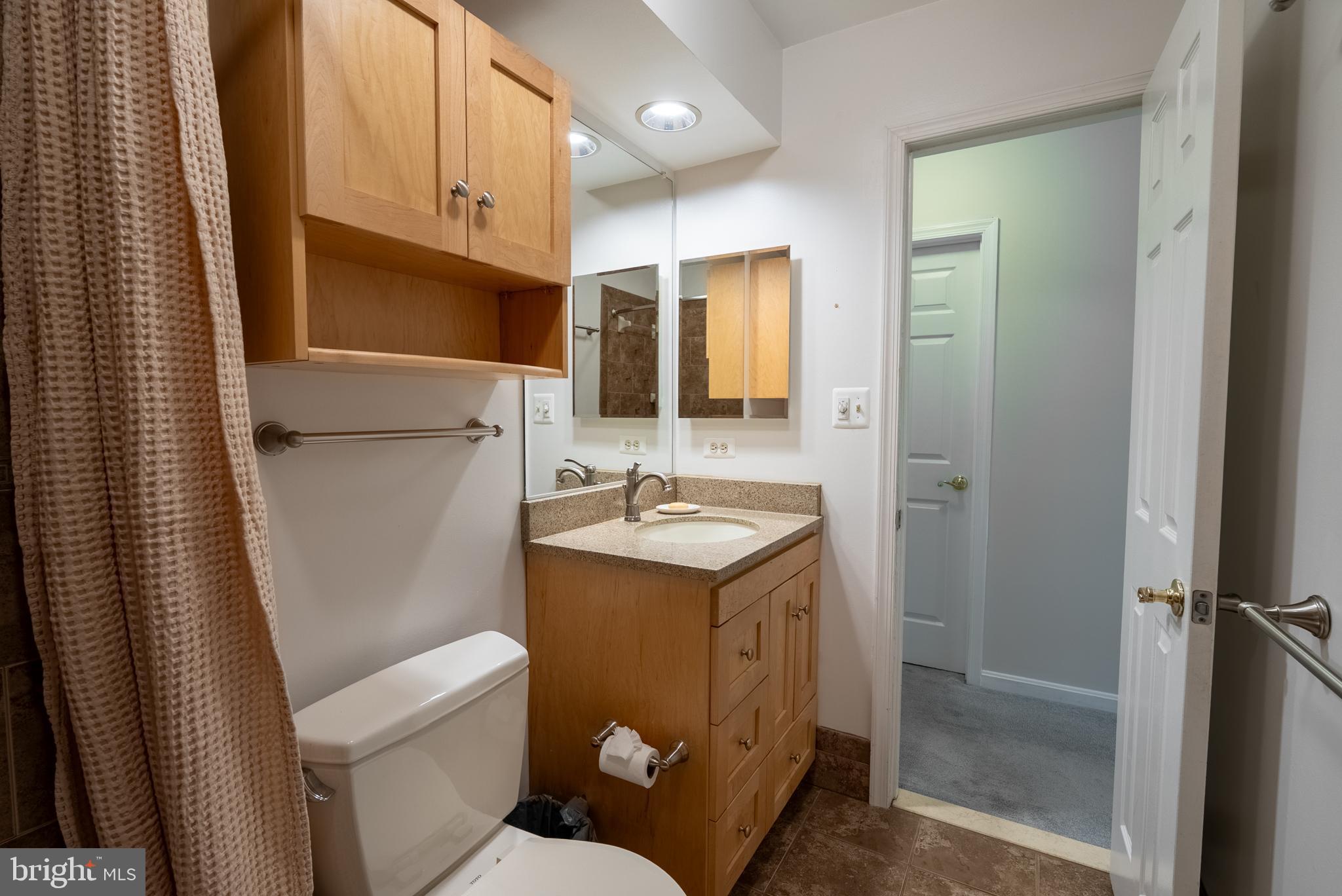 8007 Craddock Road Greenbelt, MD 20770 - Photo 32 of 59 Modern bathroom with warm wood accents.