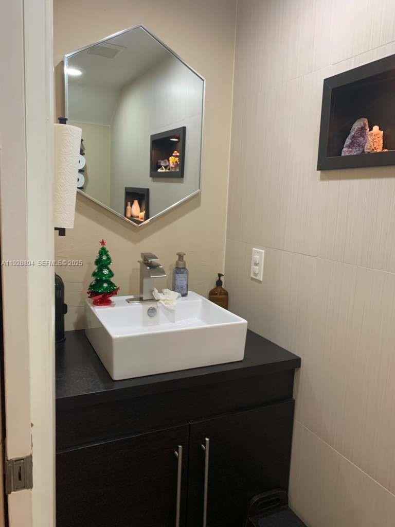 15228 Southwest 111th Street Miami, FL 33196 - Photo 18 of 27 a bathroom with a sink and a mirror