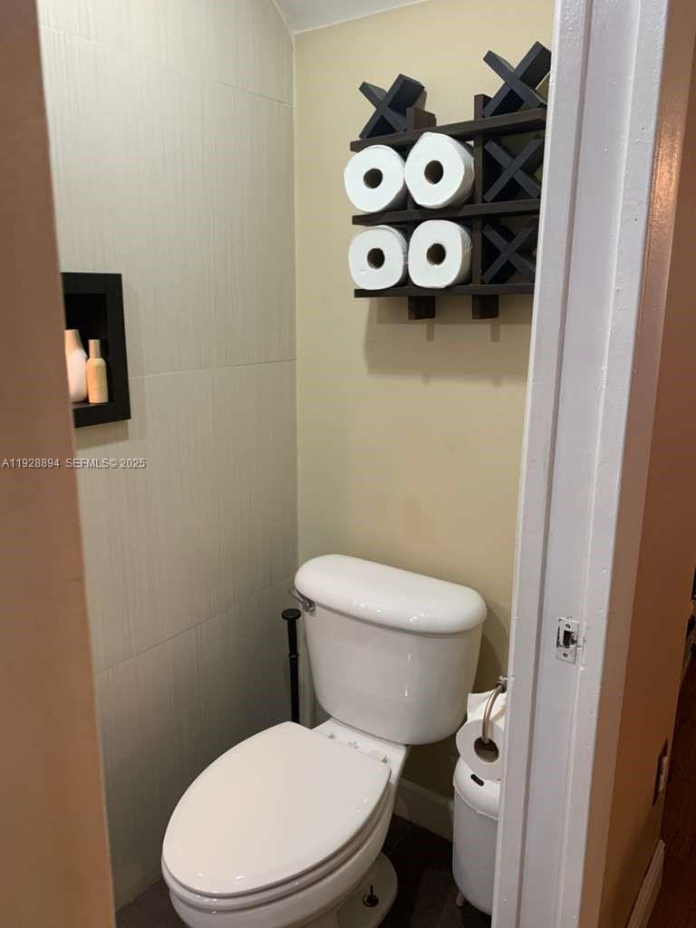 15228 Southwest 111th Street Miami, FL 33196 - Photo 19 of 27 a white toilet sitting next to a white tub
