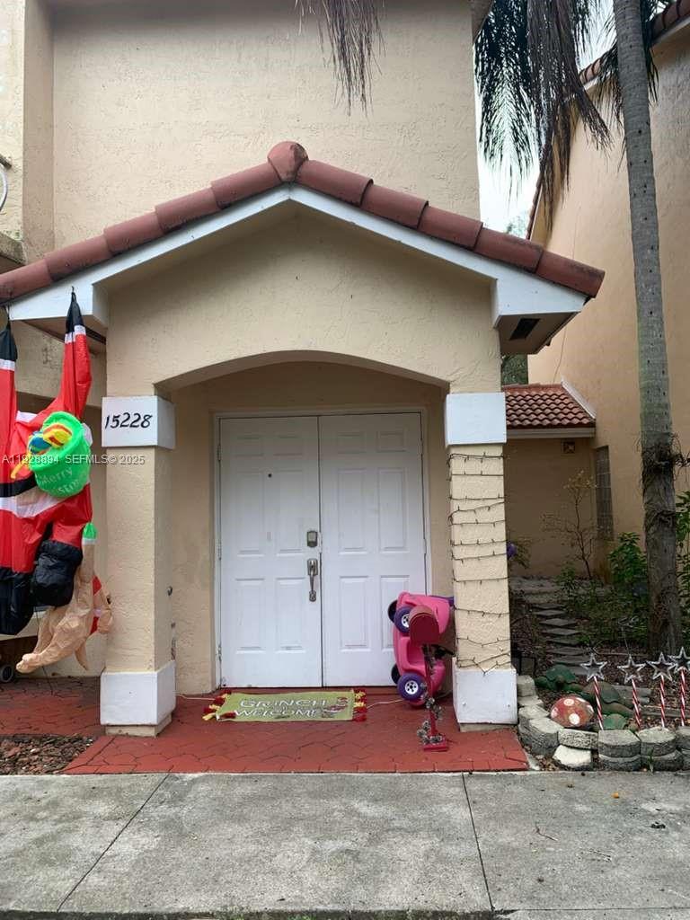 15228 Southwest 111th Street Miami, FL 33196 - Photo 2 of 27 a house with glass top table and chairs
