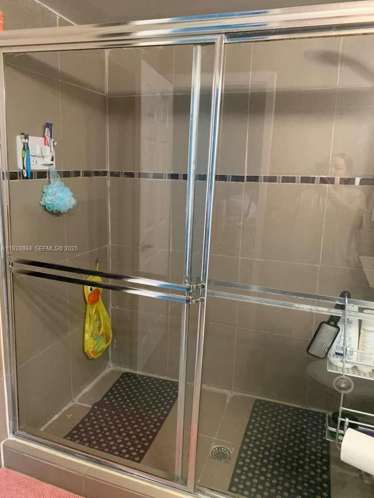 15228 Southwest 111th Street Miami, FL 33196 - Photo 21 of 27 a bathroom with a shower