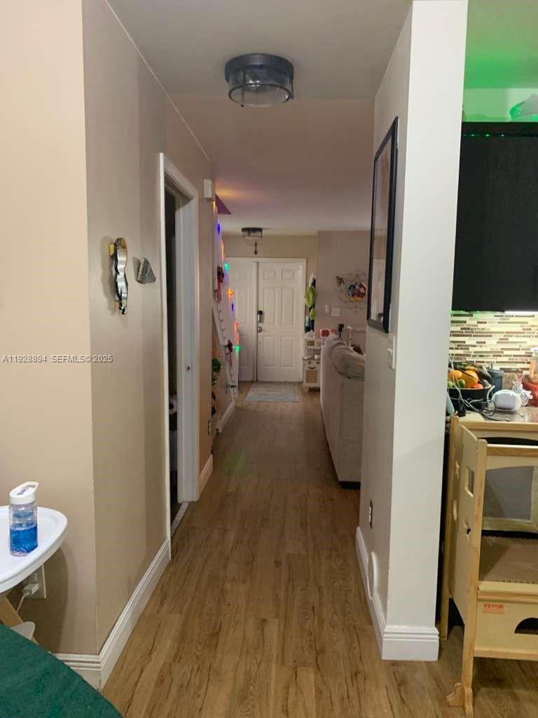 15228 Southwest 111th Street Miami, FL 33196 - Photo 26 of 27 a view of a kitchen from the hallway