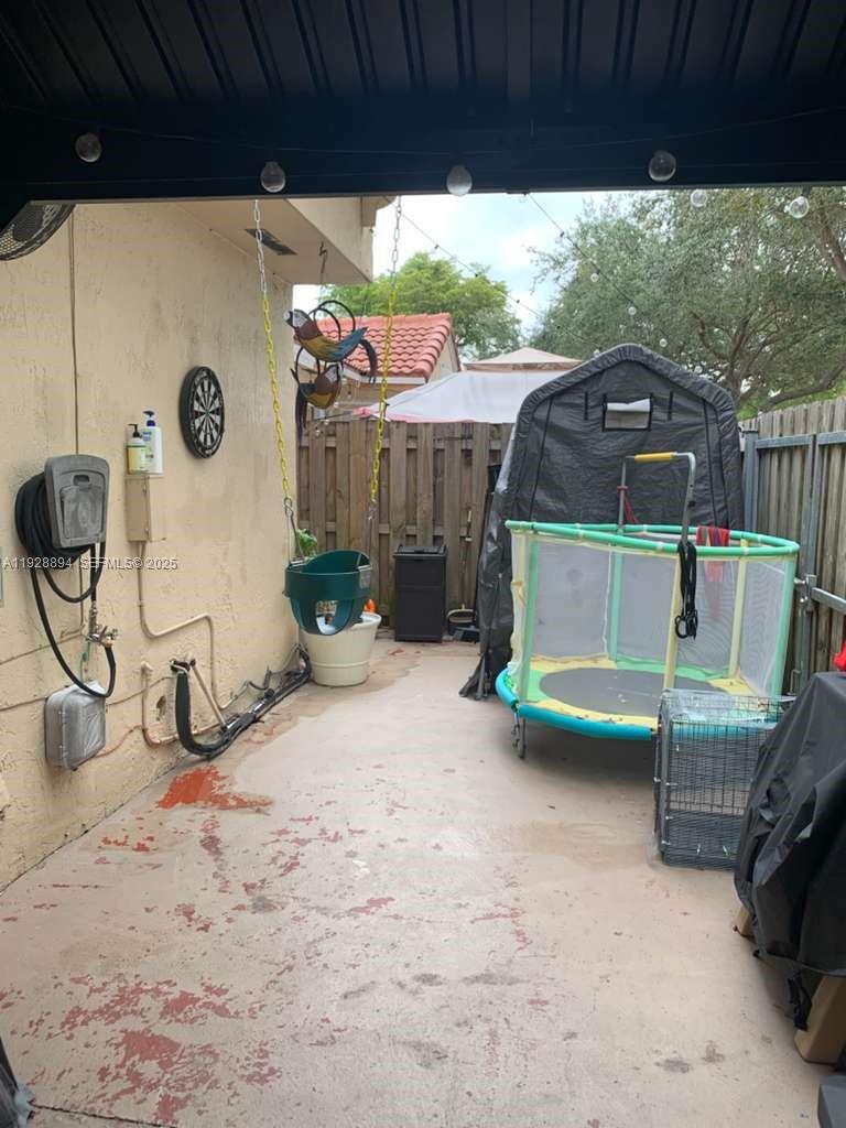 15228 Southwest 111th Street Miami, FL 33196 - Photo 27 of 27 a view of a porch with furniture and a yard