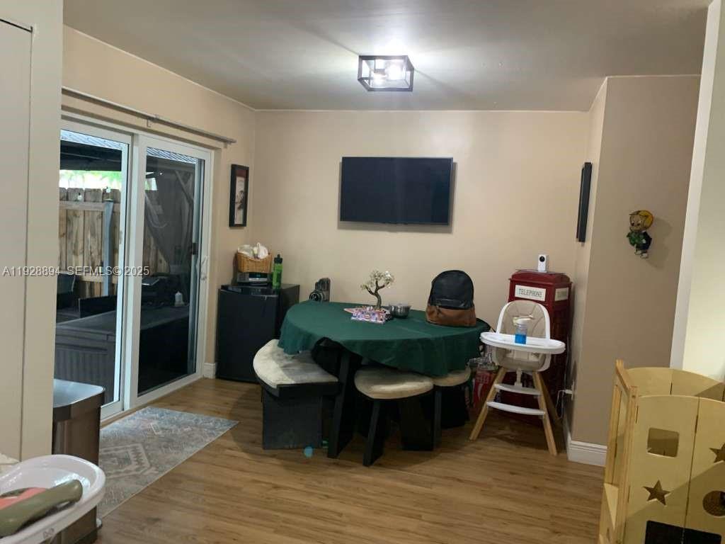 15228 Southwest 111th Street Miami, FL 33196 - Photo 4 of 27 a living room with furniture and a flat screen tv