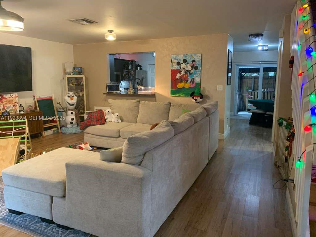 15228 Southwest 111th Street Miami, FL 33196 - Photo 5 of 27 a living room with furniture and a flat screen tv